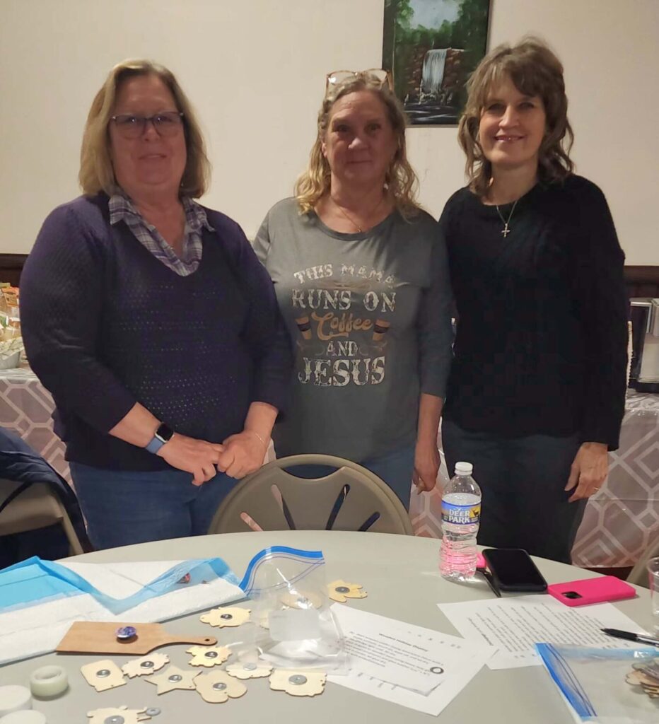 Three women making art crafts